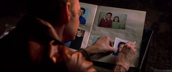Movie still from “Freddy vs. Jason” (2003), directed by Ronny Yu – A man is looking at pictures in a photo album; Extreme Close Up shot, High angle