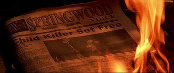 Movie still from “Freddy vs. Jason” (2003), directed by Ronny Yu – An old newspaper with the headline " killer set free " on it; Extreme Close Up shot, High angle