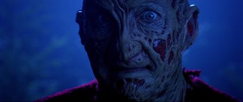 Movie still from “Freddy vs. Jason” (2003), directed by Ronny Yu – A person with a face covered in blood; Close Up shot, Low angle