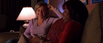 Movie still from “Freddy vs. Jason” (2003), directed by Ronny Yu – Two women are laughing together at a party; Medium shot, Over the shoulder angle