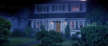Movie still from “Freddy vs. Jason” (2003), directed by Ronny Yu – A night time picture of a house with a yellow door; Extreme Wide shot, High angle