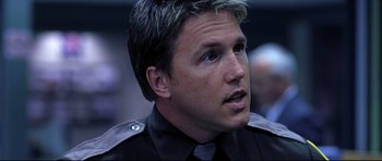 Movie still from “Freddy vs. Jason” (2003), directed by Ronny Yu – A person wearing a police uniform; Close Up shot, Over the shoulder angle