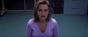 Movie still from “Freddy vs. Jason” (2003), directed by Ronny Yu – A young woman with short brown hair wearing a purple shirt; Close Up shot, High angle