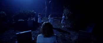 Movie still from “Freddy vs. Jason” (2003), directed by Ronny Yu – A group of young children playing with a rope in the dark; Wide shot, High angle