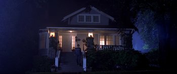 Movie still from “Freddy vs. Jason” (2003), directed by Ronny Yu – A person walking down the steps of a house at night; Wide shot, Low angle