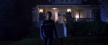 Movie still from “Freddy vs. Jason” (2003), directed by Ronny Yu – A man standing in front of a house at night; Wide shot, Low angle