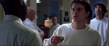 Movie still from “Freddy vs. Jason” (2003), directed by Ronny Yu – A young man holding a cup in his hand; Close Up shot, Over the shoulder angle