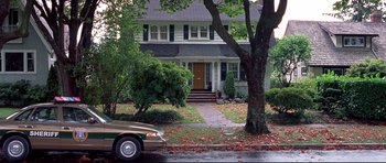 Movie still from “Freddy vs. Jason” (2003), directed by Ronny Yu – A car is parked in front of a house; Extreme Wide shot, High angle