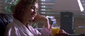Movie still from “Freddy vs. Jason” (2003), directed by Ronny Yu – A woman sitting at a table with a glass of orange juice; Close Up shot, Over the shoulder angle