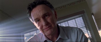 Movie still from “Freddy vs. Jason” (2003), directed by Ronny Yu – An older man is looking into the camera; Close Up shot, Low angle