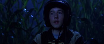 Movie still from “Freddy vs. Jason” (2003), directed by Ronny Yu – A young man wearing a motorcycle helmet in the dark; Close Up shot, Low angle
