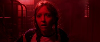 Movie still from “Freddy vs. Jason” (2003), directed by Ronny Yu – A woman with pigtails in a dark room; Close Up shot, Low angle