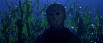 Movie still from “Freddy vs. Jason” (2003), directed by Ronny Yu – A man with a hockey mask is standing in the grass; Close Up shot, Low angle