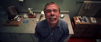 Movie still from “Freddy vs. Jason” (2003), directed by Ronny Yu – A man with his mouth wide open sitting at a table; Medium shot, Overhead angle