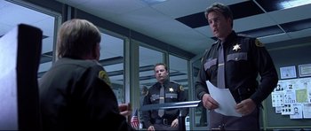 Movie still from “Freddy vs. Jason” (2003), directed by Ronny Yu – A couple of men standing next to each other in a room; Medium shot, Low angle