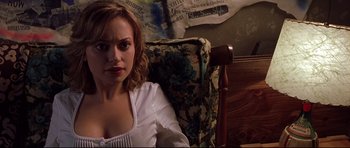 Movie still from “Freddy vs. Jason” (2003), directed by Ronny Yu – A woman sitting in a chair in front of a wall; Medium shot, High angle