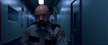 Movie still from “Freddy vs. Jason” (2003), directed by Ronny Yu – A man in a police uniform standing in a hallway; Close Up shot, Low angle