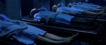 Movie still from “Freddy vs. Jason” (2003), directed by Ronny Yu – A person is laying on a bed in front of a mirror; Wide shot, High angle