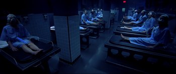 Movie still from “Freddy vs. Jason” (2003), directed by Ronny Yu – A group of people sitting in a room at night; Wide shot, High angle