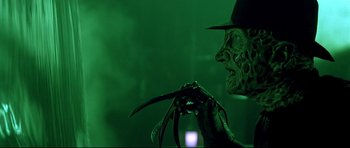Movie still from “Freddy vs. Jason” (2003), directed by Ronny Yu – A person holding a knife; Close Up shot, Low angle