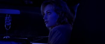 Movie still from “Freddy vs. Jason” (2003), directed by Ronny Yu – A woman sitting in a car at night with blue lights; Close Up shot, Over the shoulder angle