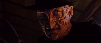 Movie still from “Freddy vs. Jason” (2003), directed by Ronny Yu – The face of a man in a hat; Close Up shot, Low angle