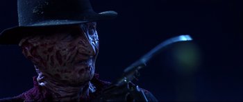 Movie still from “Freddy vs. Jason” (2003), directed by Ronny Yu – A person holding a knife; Close Up shot, Low angle
