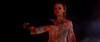 Movie still from “Freddy vs. Jason” (2003), directed by Ronny Yu – A woman in a white shirt is holding her arm up; Medium shot, Over the shoulder angle