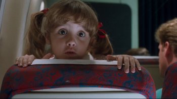 Movie still from “Freddy's Dead: The Final Nightmare” (1991), directed by Rachel Talalay – A little girl is peeking over the top of a box; Close Up shot, Low angle