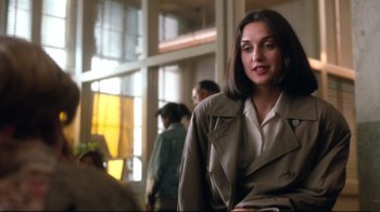 Movie still from “Freddy's Dead: The Final Nightmare” (1991), directed by Rachel Talalay – A woman wearing a trench coat in front of a window; Close Up shot, Over the shoulder angle