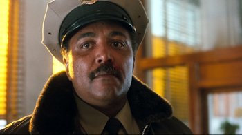 Movie still from “Freddy's Dead: The Final Nightmare” (1991), directed by Rachel Talalay – A police officer wearing a hat and a jacket; Close Up shot, Low angle