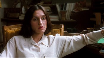 Movie still from “Freddy's Dead: The Final Nightmare” (1991), directed by Rachel Talalay – A woman sitting in a chair in front of a table; Close Up shot, High angle