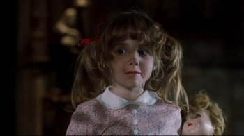 Movie still from “Freddy's Dead: The Final Nightmare” (1991), directed by Rachel Talalay – A little girl with pigtails and a red bow in her hair; Close Up shot, High angle