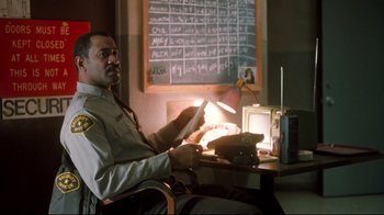 Movie still from “Freddy's Dead: The Final Nightmare” (1991), directed by Rachel Talalay – A man sitting at a desk in front of a blackboard; Medium shot, Low angle