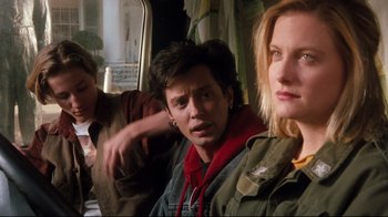 Movie still from “Freddy's Dead: The Final Nightmare” (1991), directed by Rachel Talalay – A man and two women sitting next to each other on a bus; Medium shot, Low angle