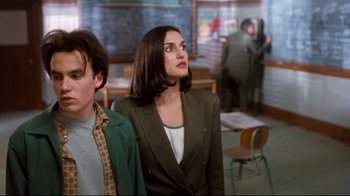 Movie still from “Freddy's Dead: The Final Nightmare” (1991), directed by Rachel Talalay – A woman standing next to a man in a classroom; Medium shot, Over the shoulder angle