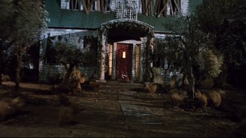 Movie still from “Freddy's Dead: The Final Nightmare” (1991), directed by Rachel Talalay – An abandoned building with a red bicycle in front of it; Extreme Wide shot, Low angle