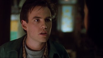 Movie still from “Freddy's Dead: The Final Nightmare” (1991), directed by Rachel Talalay – A young man with short brown hair looking to his left; Close Up shot, Low angle