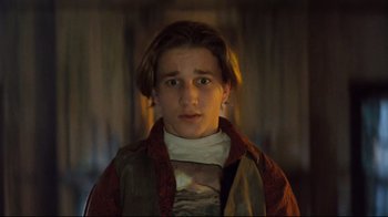 Movie still from “Freddy's Dead: The Final Nightmare” (1991), directed by Rachel Talalay – A young man in a brown and red jacket; Close Up shot, Low angle