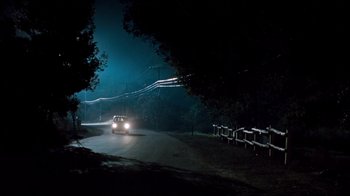Movie still from “Freddy's Dead: The Final Nightmare” (1991), directed by Rachel Talalay – A car driving down a road at night; Extreme Wide shot, High angle
