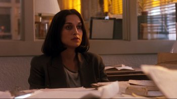 Movie still from “Freddy's Dead: The Final Nightmare” (1991), directed by Rachel Talalay – A woman sitting at a table with papers in front of her; Medium shot, Over the shoulder angle