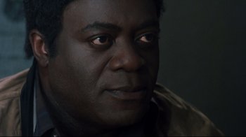 Movie still from “Freddy's Dead: The Final Nightmare” (1991), directed by Rachel Talalay – A man's face in a dimly - lit room; Close Up shot, High angle
