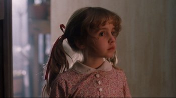 Movie still from “Freddy's Dead: The Final Nightmare” (1991), directed by Rachel Talalay – A little girl with long hair in a pink dress; Close Up shot, Low angle
