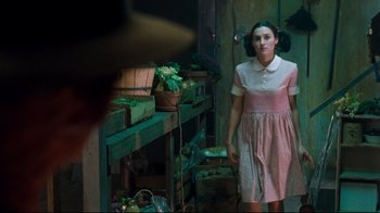 Movie still from “Freddy's Dead: The Final Nightmare” (1991), directed by Rachel Talalay – A woman in a pink dress standing in front of a table; Medium shot, Over the shoulder angle