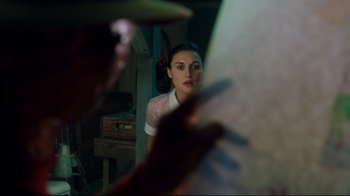 Movie still from “Freddy's Dead: The Final Nightmare” (1991), directed by Rachel Talalay – A woman looking into a mirror while holding a frisbee in her hand; Close Up shot, Over the shoulder angle