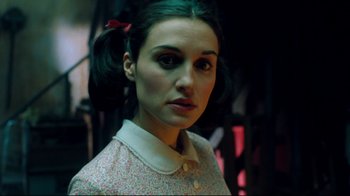 Movie still from “Freddy's Dead: The Final Nightmare” (1991), directed by Rachel Talalay – A young woman with dark green hair wearing a pink bow; Close Up shot, Low angle