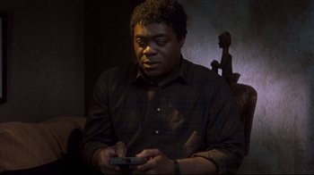 Movie still from “Freddy's Dead: The Final Nightmare” (1991), directed by Rachel Talalay – A man holding a cell phone in his hands; Medium shot, High angle