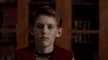 Movie still from “Freddy's Dead: The Final Nightmare” (1991), directed by Rachel Talalay – A young boy in a red vest stares into the camera; Close Up shot, Low angle