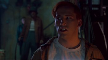 Movie still from “Freddy's Dead: The Final Nightmare” (1991), directed by Rachel Talalay – A man with red hair and a white shirt is looking at the camera; Close Up shot, Low angle