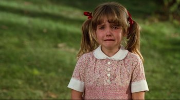 Movie still from “Freddy's Dead: The Final Nightmare” (1991), directed by Rachel Talalay – A little girl that is standing in the grass with her eyes closed; Close Up shot, High angle